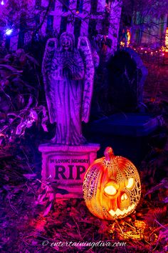 a halloween scene with pumpkins and an angel statue