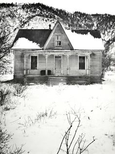 an old house with snow on the ground