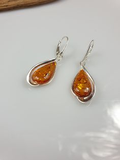 Welcome to my handmade shop. Item description: Sterling silver 925 earrings with Amber and all hallmarks. Length: 5 cm This item was made of natural Baltic Amber. All the amber used in my jewelry is collected in my home country Lithuania. I sell only genuine, real, not pressed, authentic, natural Baltic Amber. Item may have natural imperfections. Due to amber being natural, each of my jewelry is unique and even the same models can be slightly different. Please contact me for more details, photos Elegant Amber Teardrop Earrings, Classic Amber Earrings For Gift, Classic Amber Teardrop Jewelry, Elegant Amber Earrings With Polished Finish, Classic Teardrop Amber Jewelry, Amber Drop Earrings For Formal Occasions, Round Teardrop Pierced Earrings For Anniversary, Silver Pear-shaped Earrings With Polished Finish, Anniversary Round Teardrop Pierced Earrings