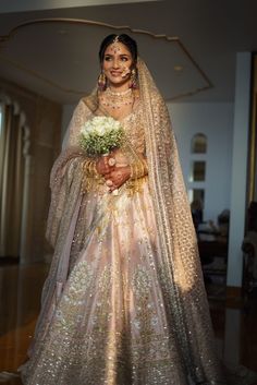 a woman in a bridal gown holding a bouquet