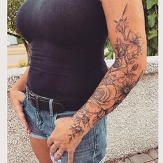 a woman with a flower tattoo on her arm