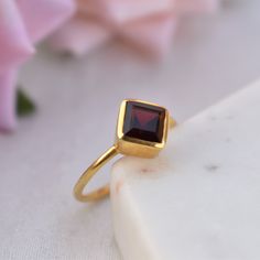 D E T A I L S - Stone: Natural Garnet Stone Shape: Cushion - Square Material: Sterling silver The fit: True to US ring size Finish: Smooth and Gold Plated to a high shine S H I P P I N G & P R O D U C T I O N - My current production time is 2-6 business days, which means after those days are up, your order ships! I make everything custom to order, by hand, but I promise you it's worth the wait! R U S H - M Y - O R D E R - If you're in a rush to get your pretty new pieces, please send me a me January Birthstone Rings, Chalcedony Ring, Lapis Lazuli Ring, Textured Ring, Citrine Ring, Everyday Rings, Garnet Stone, Proposal Ring, Gold Plated Rings