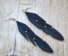 "Black Long dangle earrings Raven feather jewelry Statement earrings Gothic jewelry Gift for her Polymer clay jewelry for women Halloween jewelry A mysterious gothic earrings are made of polymer clay and imitate black raven feathers with silver color bead spacers. Each feather is hand-sculpted and textured. Earring size: 7,2 X 1,5cm (2,83 X 0,59\") Can be made in different colors and sizes. Looking for matching necklace? Get the set of necklace and earrings by this link: https://www.etsy.com/lis Adjustable Black Feather Jewelry, Nickel-free Black Polymer Clay Jewelry, Black Polymer Clay Jewelry With Ear Wire, Black Bohemian Polymer Clay Jewelry, Bohemian Black Jewelry Made Of Polymer Clay, Bohemian Black Polymer Clay Jewelry, Raven Feather, Raven Jewelry, Earrings Gothic