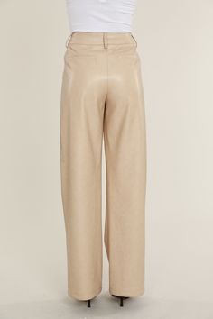 Elevate your professional outfits (or even just your everyday looks) with an edgy wardrobe staple like our Faux Leather Wide Leg Trouser Pants. Tailored to perfection, these wide legged trousers offer a relaxed yet polished vibe, ideal for curating a smart casual look. The sleek faux leather material lends a modern edge, while the wide leg cut ensures a comfortable, airy feel. Pair these with a crisp blouse or a casual tee to create versatile looks that transition effortlessly from office hours Chic Wide-leg Leather Pants For Workwear, Sleek Wide Leg Leather Pants For Spring, Faux Leather Wide Leg Pants For Work, Wide Leg Faux Leather Work Pants, Leather Wide Leg Pants For Workwear In Fall, Elegant Wide Leg Faux Leather Pants, Elegant Faux Leather Wide Leg Pants, Elegant Faux Leather Wide-leg Pants, Elegant Wide-leg Faux Leather Pants