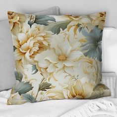 a pillow with yellow and white flowers on it