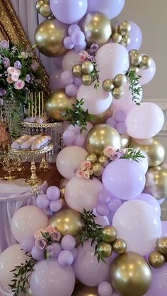 a table topped with lots of balloons and flowers