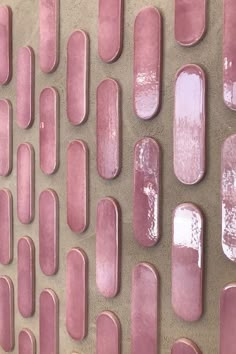 a wall made out of pink tiles on the side of a building