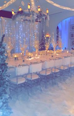 a dining room set up for christmas with lights on the ceiling and snow covered ground