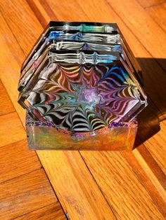 a glass vase sitting on top of a wooden floor