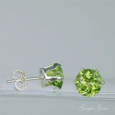 "Peridot is a beautiful bright lime green genuine gemstone which is natural and untreated. These are clear and sparkling large 7mm round 2.80ctw Peridots which are set into sterling silver castings with butterfly backs. Peridot is a birthstone for August. The cut and clarity of these gemstones is excellent. The \"model\" for the earrings is only a photograph, not a real person wearing the earrings. The ear is scaled to an average sized ear. Peridot Lore: Peridot was known as the \"gem of the sun Classic Green Round Earrings, Classic Green Peridot Earrings, Green Brilliant-cut Earrings For May Birthstone, Green Brilliant Cut Earrings For May Birthstone, Classic Green Hypoallergenic Jewelry, Green Brilliant Round Cut Earrings, Green Round Cut Earrings As Gift, Green Round Earrings With Prong Setting, Classic Green Round Cut Earrings