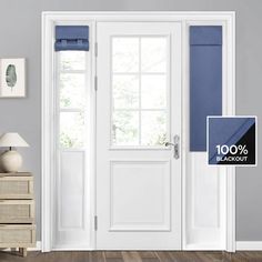 an open white door with blue blinds in front of it and a lamp on the side table