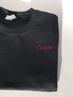 This listing is for a custom embroidered UNISEX crewneck sweatshirt. The more text you add the smaller the text will be. Interested in a different sweatshirt color, thread color, font, etc? Message us on Etsy to make a request. Please see the size chart in the product listing photos to determine the best size for you. Custom embroidered sweatshirts make a gift for any occasion - anniversary, bachelor party, bachelorette party, back to school, birthday, engagement, graduation, sweet 16's and quinceañera's, retirement, and weddings. They're also perfect for any holiday because this sweatshirt is customizable - Valentine's Day, St. Patrick's Day, Easter, Mother's Day, Father's Day, Halloween, Thanksgiving, Hanukkah, Christmas, and more. Or this could be a wonderful treat for yourself. These s Crew Neck T-shirt With Custom Embroidery, Black Letter Embroidery T-shirt For Streetwear, Black Embroidered Crew Neck Sweatshirt, Black Long Sleeve Sweatshirt With Custom Text, Black Crew Neck Top With Letter Embroidery, Black Crew Neck Sweatshirt With Letter Embroidery, Black Long Sleeve Embroidered T-shirt, Casual Black Sweatshirt With Custom Text, Black Crew Neck T-shirt With Embroidered Text