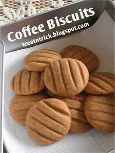 some cookies are sitting in a box on a table with the words coffee biscuits