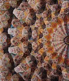 an overhead view of colorful umbrellas with intricate designs on the top and bottom half