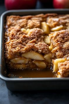 a close up of an apple pie in a pan