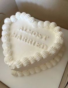 a heart - shaped cake with frosting that reads, most married on the inside