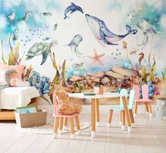 a child's room decorated in pastel colors and under the sea animals mural