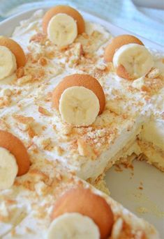 there is a cake with bananas on top and frosting in the middle that has been cut into pieces