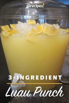 there is a lemon punch in the glass with ice and garnishes on it