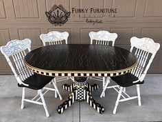 a black and white dining table with four chairs around it in front of a garage door