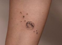 a woman's arm with stars and the moon on it