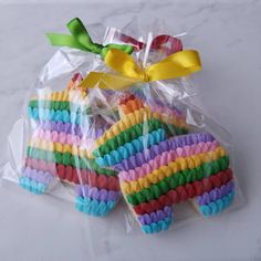 small rainbow cookies wrapped in cellophane and tied with a green bow