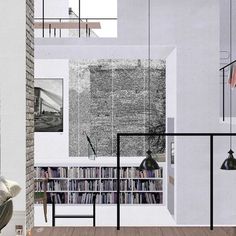 a room with bookshelves, lamps and pictures on the wall