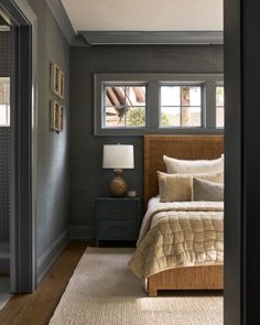 a bed sitting in a bedroom next to a window