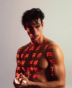 a shirtless man with chinese writing on his chest