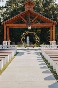 an outdoor ceremony setup with white chairs