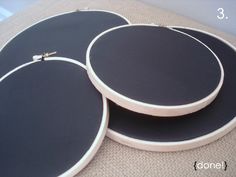 three large black and white drum heads sitting on top of each other