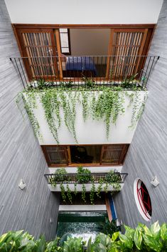 an apartment building with plants growing on the balconies