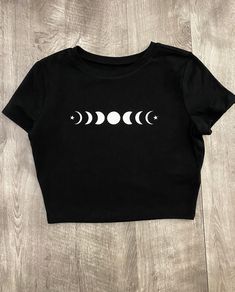 Crop top is very comfortable and has high quality iron on vinyl for the design. Materials: 57% Cotton 38% Recycled Polyester 5% Spandex Care Instructions: Flip inside out then you can machine wash and lay flat to dry or use low heat in dryer. Homemade Shirts, Fitted Crop Top, Comfy Casual Outfits, Moon T Shirt, Goth Clothing, Phases Of The Moon, Workout Crop Top, Black Crop Top, Crop Top And Shorts