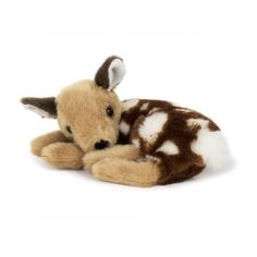 a brown and white stuffed animal laying down