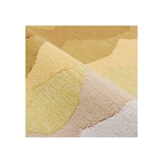 an area rug with different colors and shapes on it, including yellow, grey, beige and white