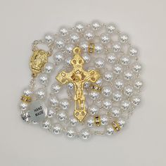 "A beautiful rosary made of high quality pearl beads. Fully handcrafted with each bead individually cut, polished and drilled by expert craftsmen. This rosary is not only a long lasting piece of jewellery but also the perfect gift for yourself or someone special in your life. The Our Lady Fatima with the three Little Shepherds at Her feet Center on one side and water from the fountain of the Sanctuary of Fatima on the other.  With this special center piece and the very original Crucifix makes th Round Polished Bead Rosary As Gift, Polished Round Beads Rosary As Gift, Polished Round Beads Rosary For Jewelry Making, Elegant Rosary With 8mm Beads And Crucifix, Silver Pearl Rosary With 8mm Beads, Elegant Pearl Rosary With Cross, Elegant Pearl Beaded Rosary, Elegant Pearl White Pearl Rosary, Spiritual Pearl Rosary With 8mm Beads