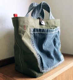 a denim bag sitting on top of a wooden shelf