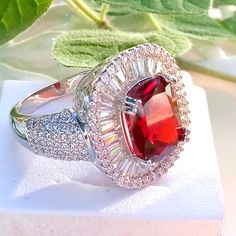 925 Silver Lab Created Red Ruby Fashion Ring. Princess Cut, Surround By Sparkling White Sapphires. Elegant Red Ruby Ring In Sterling Silver, Silver Rings With Lab-created Ruby, Party Ruby Ring With Round Shape, Round Red Ruby Party Ring, Silver Ruby Ring With Lab-created Ruby, Sterling Silver Red Jewelry With Halo Setting, Red Sterling Silver Jewelry With Halo Setting, Red Gemstone Rings For Party, Fine Jewelry Red Ruby Ring For Party