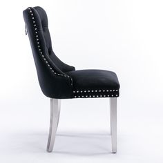 a black and silver chair with studded legs