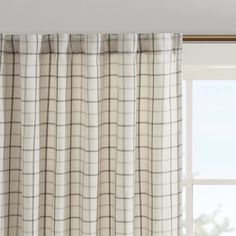 a window with a white and black checkered curtain