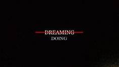 a man standing in front of a black background with the words dreaming doing on it