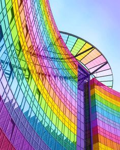 the colorful building has many windows on it's sides and is made up of multiple colors