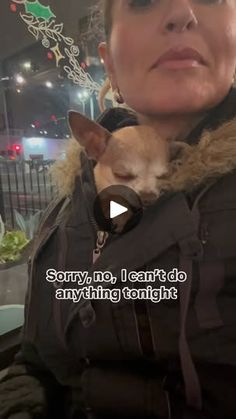 a woman holding a small dog in her lap and looking at the camera with an angry look on her face