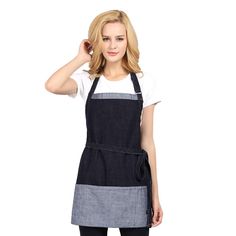 a woman wearing an apron and black pants