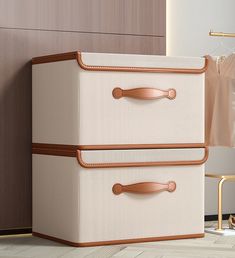 two brown and white suitcases sitting next to each other on the floor in front of a closet