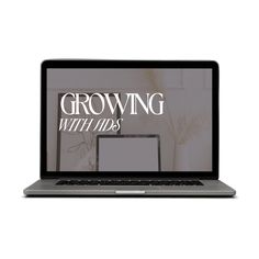 an open laptop computer sitting on top of a white surface with the words growing with this