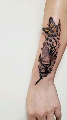 a cat with a butterfly on its head is shown in this tattoo design by the artist