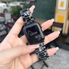 a woman is holding up her watch in front of the camera