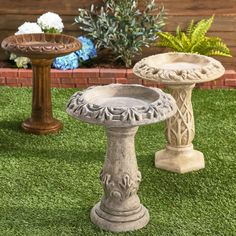 two cement pedestals sitting on top of green grass