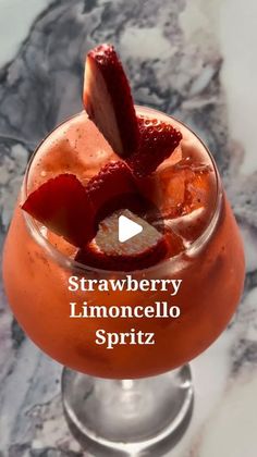 a strawberry lemoncello spritz is garnished with sliced strawberries